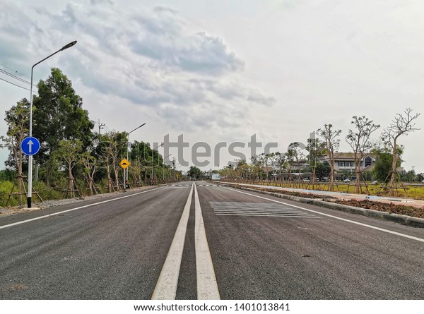 Asphalt road texture with white stripe,\
lighting poles, Road way background texture and Traffic sign.\
Traffic lines on the street. Road\
construction.