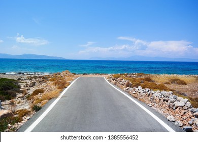Asphalt road that ends in the sea. Concepts of beginning, relaxation, harmony