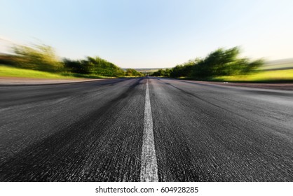 Asphalt Road Through The Green Field In Summer Day