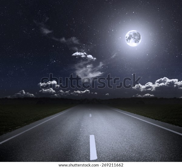 Asphalt road through the green field
and moonlight. Elements of this image furnished by
NASA