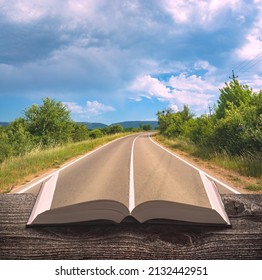 Asphalt road through the valley on a pages of an open magical book. Travel and education concept. - Powered by Shutterstock