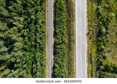 Asphalt Road And Train Railway At The Forest. Top View. Aerial Shot From Drone