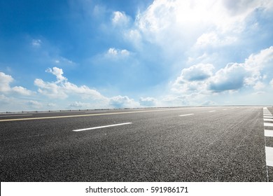 Asphalt Road Under The Blue Sky