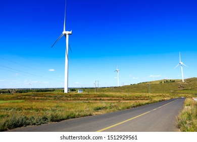 Asphalt road and wind turbines - Shutterstock ID 1512929561