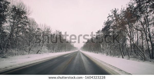 The\
asphalt road in the winter and snow weather\
outside