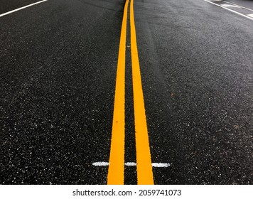 Asphalt road with yellow lines in the evening of the day with empty cars, soft and selective focus.