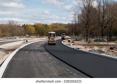 Asphalt Rollers Paving New Asphalt Driving In Line One Near Another. New Road Construction. Selective Focus.