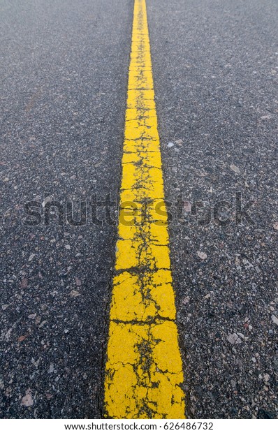 Asphalt route with straight yellow line with\
perspective without\
cars