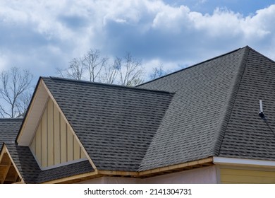 Asphalt shingles roofing construction waterproofing for new house in covered corner roof shingles - Shutterstock ID 2141304731