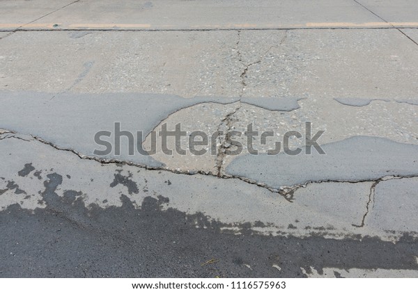 Asphalt surface on the
street was demolished due to poor construction with Water on the
cracked street 