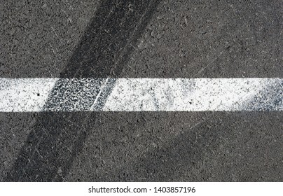 Asphalt Texture With White Line And Tire Marks . Top View