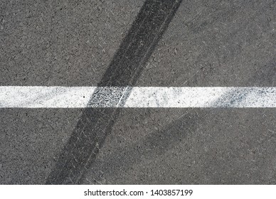 Asphalt Texture With White Line And Tire Marks . Top View