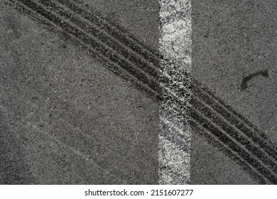 Asphalt Texture With White Line And Tire Marks. Smooth Asphalt Road. Tarmac Dark Grey Grainy Road Background.Top View