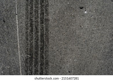 Asphalt Texture With White Line And Tire Marks. Smooth Asphalt Road. Tarmac Dark Grey Grainy Road Background.Top View