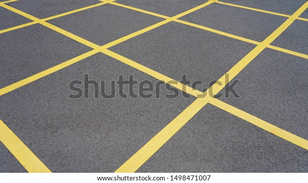  \
asphalt in yellow diagonal\
stripes. road marking. dark gray asphalt in yellow\
rhombs.