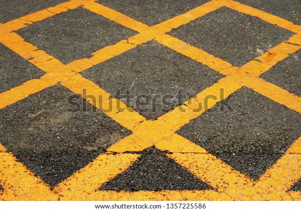 Asphalted road with yellow
cross stripes