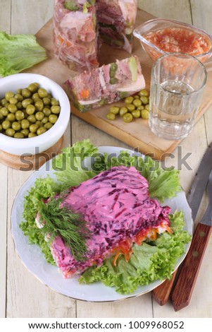 Aspic with horseradish and salad "Herring under a fur coat" served with vodka
