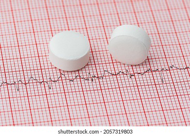 Aspirin On EKG Strip. Heart Attack, Stroke Prevention And Cardiac Heart Health Concept.