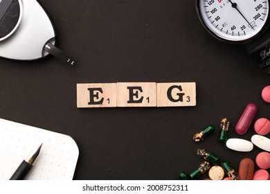 Assam, india - July 12, 2021 : Word Electroencephalography (EEG) written on wooden cubes stock image.