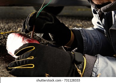 Assassin Installing Plastic Explosive Under Car Outdoor On Parking Place