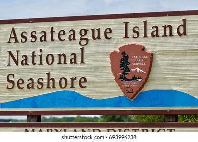 Assateague Island, Maryland - July 28, 2017: A wooden entrance sign welcomes visitors to the Maryland side of Assateauge Island National Seashore on a mid-Summer day.