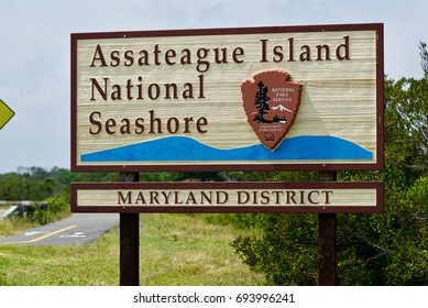 Assateague Island, Maryland - July 28, 2017: A wooden entrance sign welcomes visitors to the Maryland side of Assateauge Island National Seashore on a mid-Summer day.