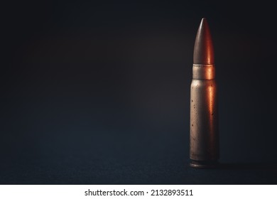 Assault Rifle Bullet On Isolated Black Background. Impressive Assault Rifle Bullet Background, Wallpaper. Minimalism Concept.