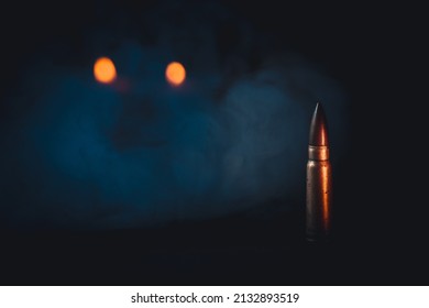 Assault Rifle Bullet On Isolated Black Background. Candles And Smoke In The Background Represent Death And Spirits. Impressive Bullet Background, Wallpaper. Minimalism And Abstract Concept.