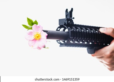 Assault Rifle With Flowers Sticking Out Of Barrel