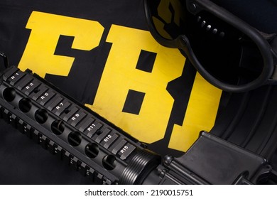 Assault Rifle And Protective Helm With Goggles On Fbi Raid Jacket Black Uniform Background