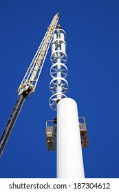 Assembilig Cell Tower With The Crane - Installation Of The Top Part With Stelath Cell Antennas.