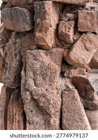 An assemblage of large granite rocks, or perhaps boulders, forms a marker near the Santa Cruz River. Detail. Chimayo NM 2026