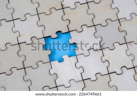 Assembled blank wooden puzzles with emphasis on the missing puzzle.