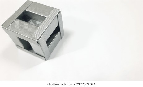 assembled staple cube from a complete pack of 1000 pieces on the isolated white