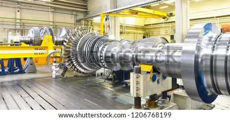 assembling and constructing gas turbines in a modern industrial factory
