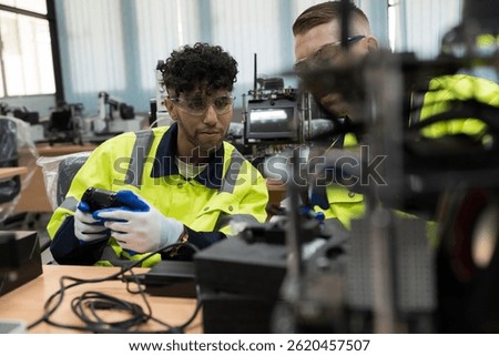 Assembling Robotic Arm. Engineer training and test programmable logic controller with AI robot training kit and mechatronics engineering in workshop