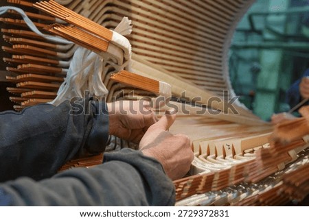 Assembling stator winding in factory workshop. Important part of power equipment and electric machines.