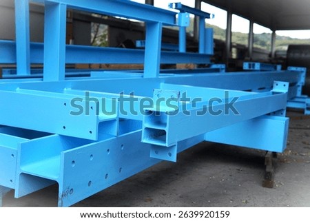 
Assembling a steel structure. A construction site where a steel structure is being assembled. A crane with heavy chains. Scaffolding provides support for workers. Bright blue and industrial landscape