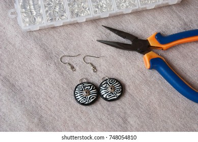 Assembly Of Black And White Bib Tribal Earrings From Polymer Clay In African Style. Unfinished Jewelry With Tools.