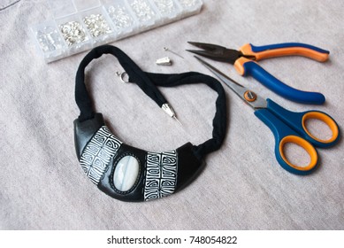 Assembly Of Black And White Bib Tribal Necklace From Polymer Clay In African Style. Unfinished Jewelry With Tools.