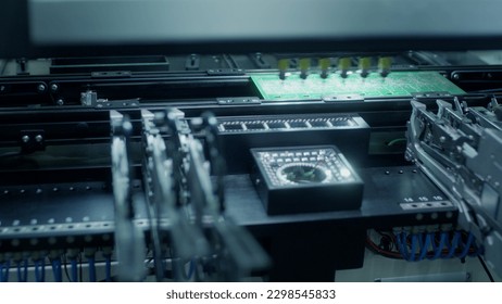 Assembly of computer circuit board: automatic SMD pick and place machine during work. Automated technology, industrial, robotic, electronic, production, manufacturing concept.