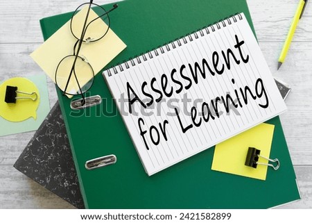 Assessment For Learning text on a notebook on a green folder