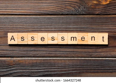 assessment word written on wood block. assessment text on table, concept.