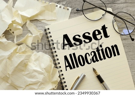 asset allocation concept text in an open notebook. near the torn paper