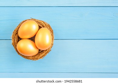 Asset Allocation For Growth, Sustainable Portfolio, Long-term Wealth Management With Risk Diversification, Financial Concept : Three Golden Eggs In A Bird Nest Or A Basket On Blue Wood Background