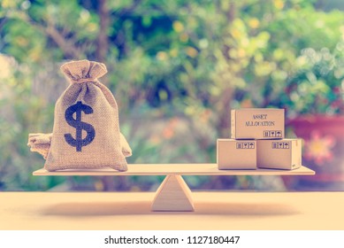 Asset Allocation And Portfolio Management Concept : Dollar Bag, Financial Product Boxes On A Simple Balance Scale, Depicts Diversifying Personal Asset For Long Term Sustainable Growth With Low Risk