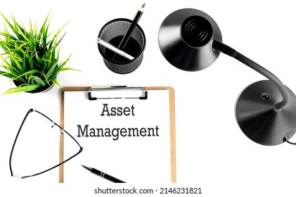 ASSET MANAGEMENT Management Written On The Paper On Clipboard With Office Tools
