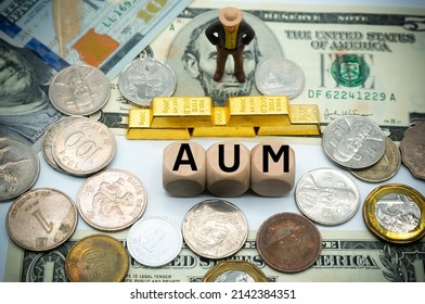 Assets under management (AUM) is the total market value of the investments that a person or entity manages on behalf of clients.The word is written on money and gold background
