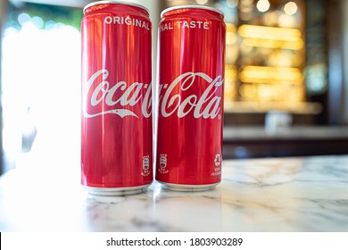 ASSISI, ITALY - AUGUST 22, 2020: Cold Coca-Cola cans on a table in a bar. Coca-Cola, or Coke, is a carbonated soft drink manufactured by The Coca-Cola Company. 