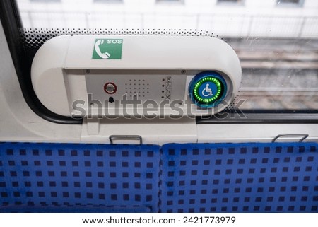 assistance button for passengers with reduced mobility in metro trains, communication with driver in Germany, concept of long-distance travel, ticket for stowaways, disability passenger support